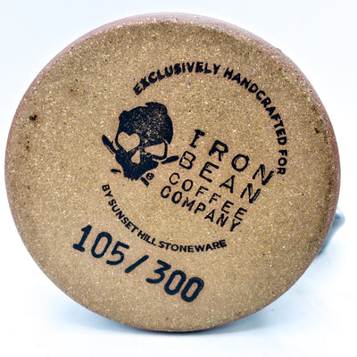 Cork coaster with 'Iron Bean Coffee Company' branding on a white background