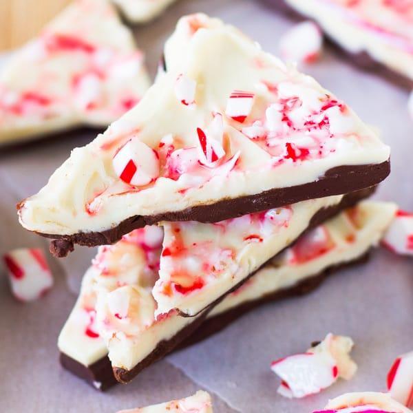 Close-up of white chocolate peppermint bark with crushed candy canes on parchment paper